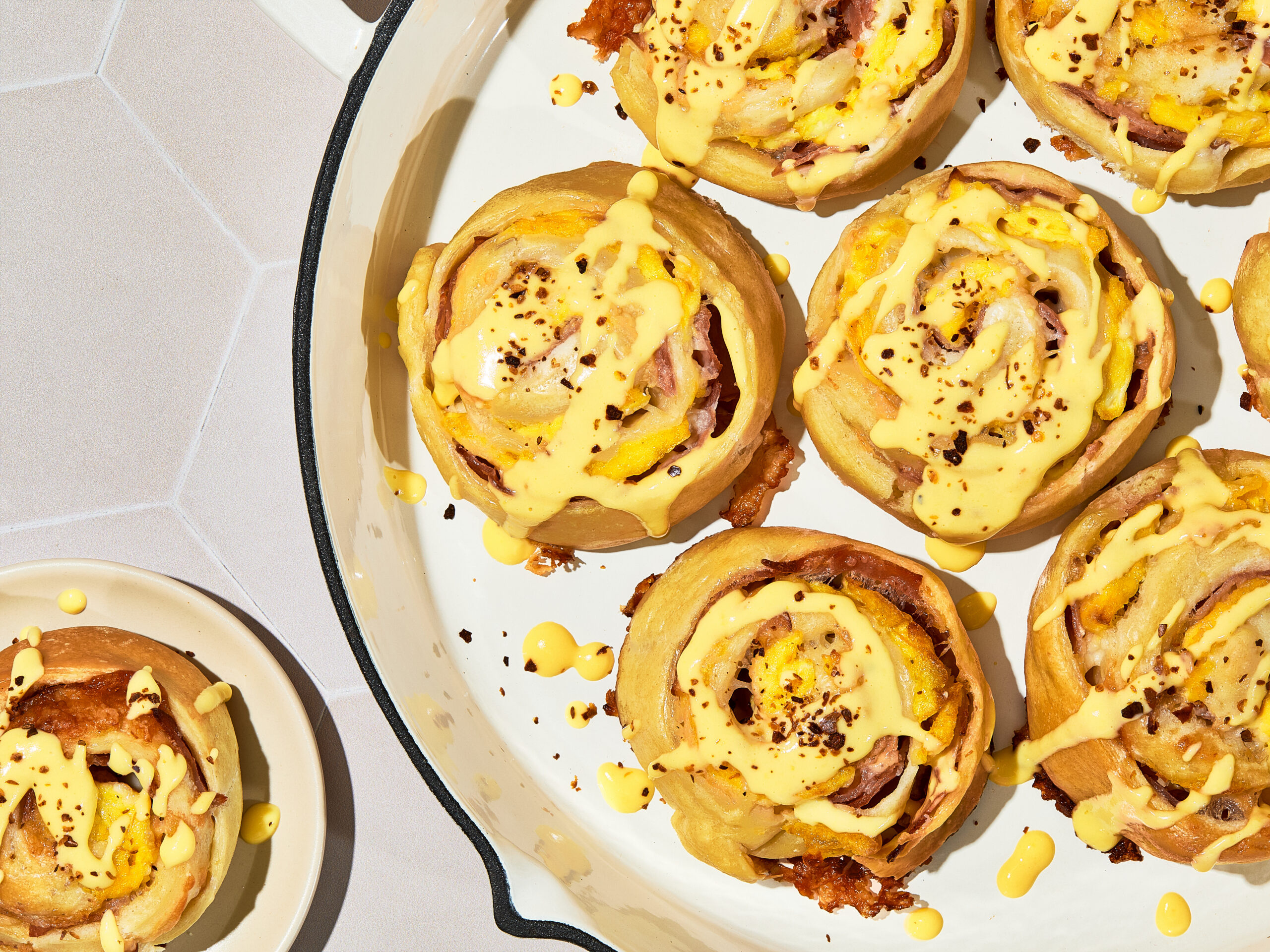 Savory Madame Rolls with hollandaise glaze, scrambled eggs, ham and Gruyere cheese
